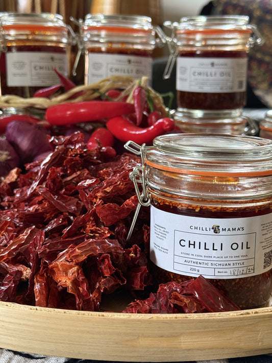 Photo showing bottle of Chilli Oil with hand-cleaned, selected er jing tao chillis.